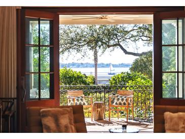 Waterfront view from a relaxing balcony, furnished with comfortable seating at 14 1/2 Murray Blvd, Charleston, SC 29401