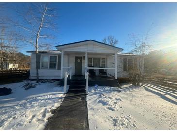 White single story home with front porch, snow covered yard, and wooden fence at 141 Nottingham Ln, Yemassee, SC 29945
