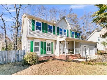 Two-story house with green shutters, brick accents, and a two-car garage at 174 Winding Rock Rd, Goose Creek, SC 29445