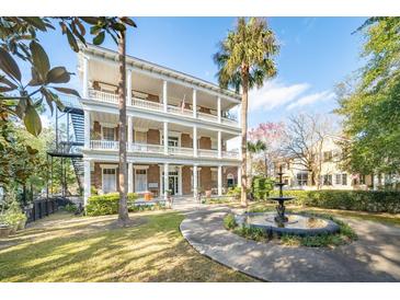 Grand two-story brick home with a fountain and lush landscaping at 12 Bee Street St # A, Charleston, SC 29403