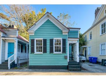 Charming light teal home with black shutters and a small front yard at 157 Line St, Charleston, SC 29403