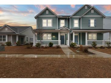 Two-story house with light teal siding, white trim, and a porch at 312 Parish Farms Dr, Summerville, SC 29486