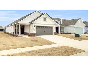 Craftsman style home with a two-car garage and brick accents at 333 Dahlia Row Dr, Summerville, SC 29486