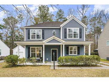 Two-story blue house with front porch and landscaped yard at 4822 Cane Pole Ln, Summerville, SC 29485