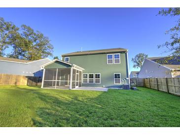 Spacious backyard with screened porch and grassy area at 5440 Overland Trl, North Charleston, SC 29420
