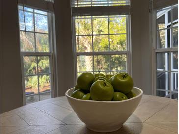 Bright dining room with hardwood floors and a farmhouse table at 3100 Sonja Way, Mount Pleasant, SC 29466