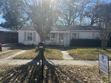 Ranch style home with a well-maintained lawn and driveway at 4329 Spur St, North Charleston, SC 29405