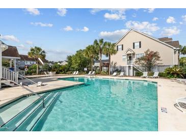 Community pool with ample lounge chairs and surrounding landscaping at 534 Mclernon Trace, Johns Island, SC 29455