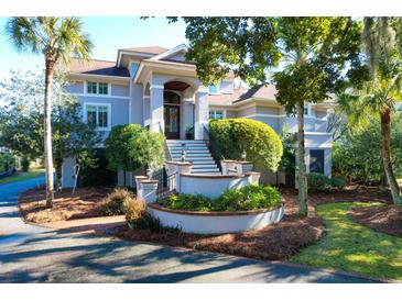 Two story home with gray siding, brown roof, and landscaped yard at 1563 Headquarters Plantation Dr, Johns Island, SC 29455