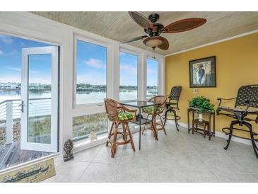 Bright sunroom with water views and comfortable seating at 25 Mariners Cay Dr, Folly Beach, SC 29439