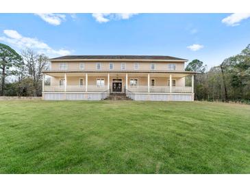 Two-story house with a large front porch and expansive lawn at 3687 Hilton Dr, Johns Island, SC 29455