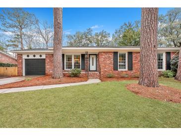 Brick ranch home with a 2-car garage and nicely landscaped yard at 2216 S Dallerton Cir, Charleston, SC 29414