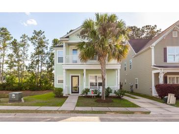 Charming two-story light green house with palm tree and walkway at 7468 Northgate Dr, Hanahan, SC 29410