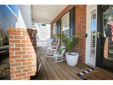 Inviting front porch with rocking chairs and brick columns at 9504 Markley Blvd, Summerville, SC 29485