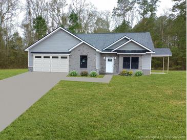 Gray brick home with white garage door and landscaped lawn at 1034 Weeks Lane, Round O, SC 29474