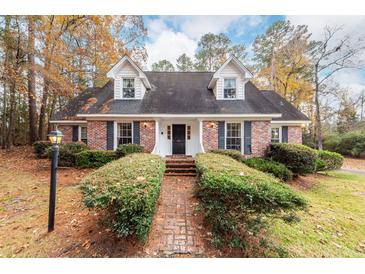 Brick ranch house with a landscaped yard and walkway at 108 Fairway Dr, Summerville, SC 29483