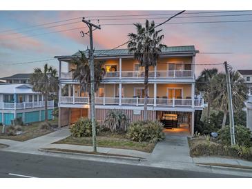 Two-story beach home with wrap-around porch and ocean views at 309 Palmetto Blvd, Edisto Island, SC 29438