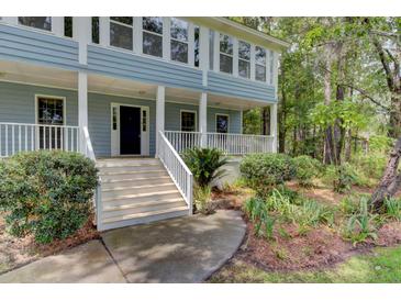 Two story house with wrap around porch and mature landscaping at 820 Pineneedle Way, Charleston, SC 29492