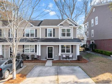 Two-story townhome with gray siding, front porch, and driveway at 9159 Parlor Dr, Ladson, SC 29456