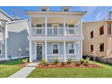 Two-story home with front porch, white columns, and landscaped yard at 131 Cantona Dr, Summerville, SC 29483