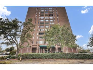 Brick building exterior with landscaping and entrance at 14 Lockwood Dr # 6H, Charleston, SC 29401