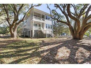 Two-story house exterior with gray siding, large windows, and a wraparound porch at 1461 Lieben Rd, Mount Pleasant, SC 29466