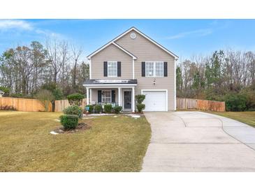 Two-story house with gray siding, attached garage, and landscaped yard at 3043 Mapleleaf Dr., Moncks Corner, SC 29461
