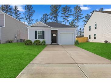 Charming one-story home with a gray exterior, landscaped lawn, and a two-car garage at 415 Broad Elm Way, Summerville, SC 29486