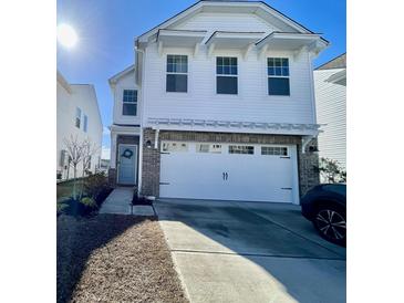 Two-story white house with gray brick accents, two-car garage, and landscaping at 515 Purple Finch Rd, Summerville, SC 29486
