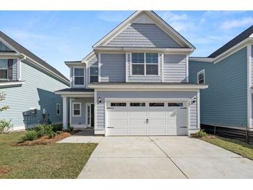 Two-story house with gray siding, white trim, and a two-car garage at 735 Opal Wing St, Moncks Corner, SC 29461