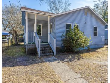 Cute blue house with a porch and steps leading to the front door at 2749 E Surrey Dr, North Charleston, SC 29405