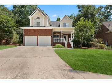 Brick two-story house with two-car garage and landscaped lawn at 8604 Fox Hollow Rd, North Charleston, SC 29420