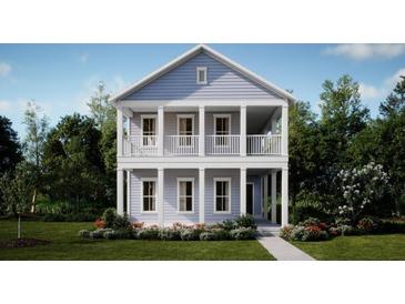 Two-story light-blue house with white columns and balcony, surrounded by lush greenery at 142 Maritime Way, Summerville, SC 29485