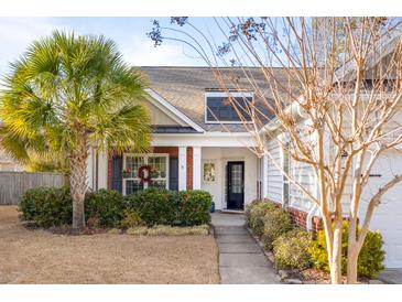 Two-story house with white siding, red brick accents, and a palm tree at 1589 Pixley St, Charleston, SC 29414