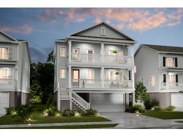 Two-story home with gray siding, balconies, and a attached garage at 1687 Siloh St # 496, Mount Pleasant, SC 29466