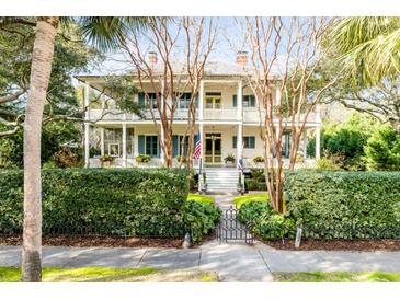 Two-story home with wrap-around porch and lush landscaping at 1738 Ion Ave, Sullivans Island, SC 29482
