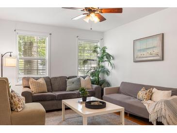Cozy living room featuring two sofas, a coffee table, and large windows at 2236 Bailey Dr, North Charleston, SC 29405