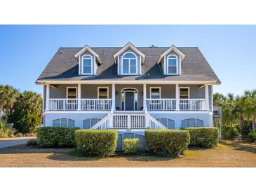 Two-story house with gray siding, white trim, and a wraparound porch at 3019 Brownell Ave, Sullivans Island, SC 29482