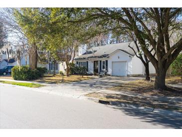 White house with a garage and mature trees in the front yard at 359 Muirfield Pkwy, Charleston, SC 29414