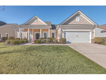 Craftsman style home with front porch and landscaped yard at 369 Waterlily Way, Summerville, SC 29486