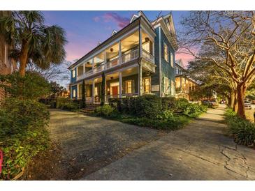 Historic two-story home with wraparound porch and landscaped yard at 66 Warren St # Entire Property, Charleston, SC 29403
