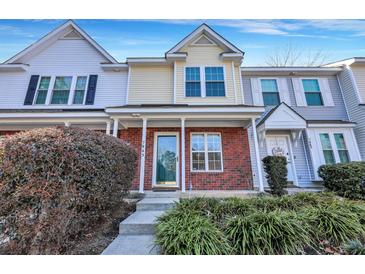 Brick front townhouse with a green door and landscaping at 7963 Shadow Oak Dr, North Charleston, SC 29406