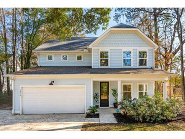 Two-story light blue house with white garage and landscaping at 1216 Ashley Hall Rd, Charleston, SC 29407