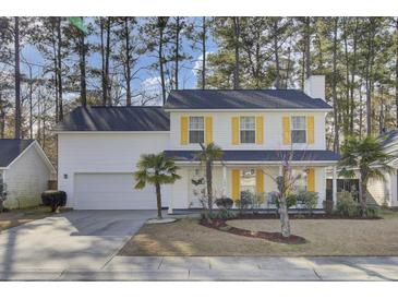 Two-story white house with yellow shutters, landscaping, and a driveway at 125 Trickle Dr, Summerville, SC 29483