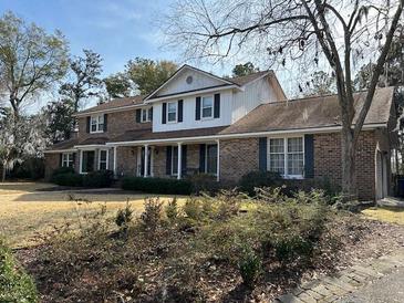 Brick house with a large front yard and mature trees at 19 Fort Royal Ave, Charleston, SC 29407