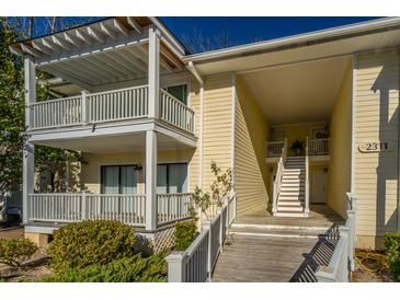 Two-story condo building with balconies and a walkway at 2311 Tall Sail Dr # B, Charleston, SC 29414