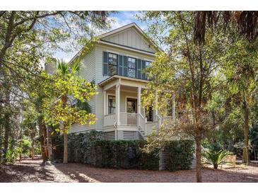 Two-story house with light green siding, dark shutters, and a wraparound porch at 2908 Old Drake Dr, Seabrook Island, SC 29455