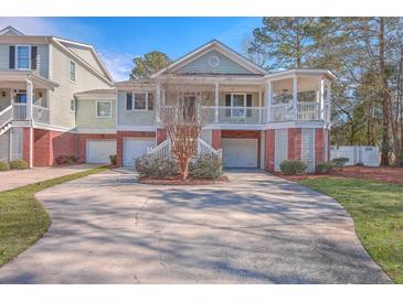 Two-story home with brick and siding, a porch, and a two-car garage at 4816 8Th Tee Dr, Hollywood, SC 29449