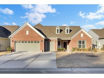 Brick home with two-car garage and landscaped yard at 482 Hidden Meadow Ln, Summerville, SC 29486