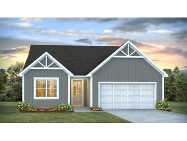 Gray exterior boasts a charming two-car garage and attractive landscaping at 136 Lilac Grove Way, Summerville, SC 29486